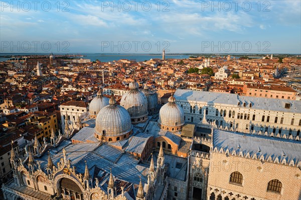 View of Venice with famous St Mark's Basilica and Doge's Palace on sunset from St Mark's Campanile bell tower