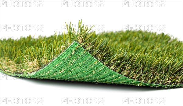 Flipped up section of artificial turf grass on white background