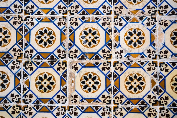 Old Portuguese tiles called azulejo found on the wall in Sesimbra