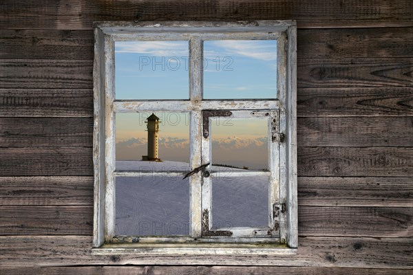 View through a rustic wooden window to the Feldberg tower