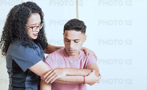 Physiotherapist with patient wrist assessment