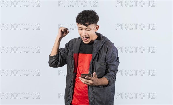Happy man holding a smartphone and celebrating