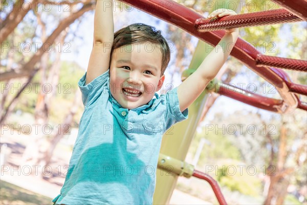 Chinese and caucasian boy having fun at the playground