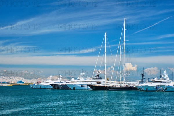 Luxury yachts and boats moored on summer day in port of Athens