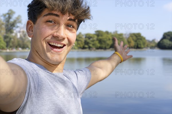  Active handsome young Caucasian man taking selfie showing around at a ...