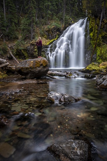 Young woman standing on stone