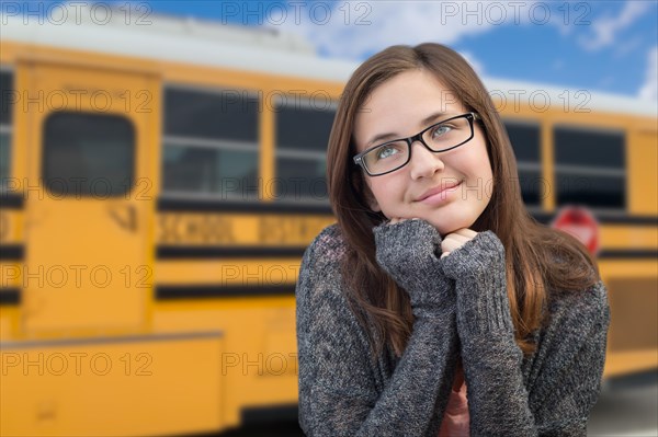 Young female student near school bus