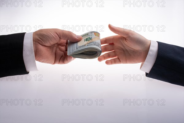 Businessman giving and receiving US dollar banknote money