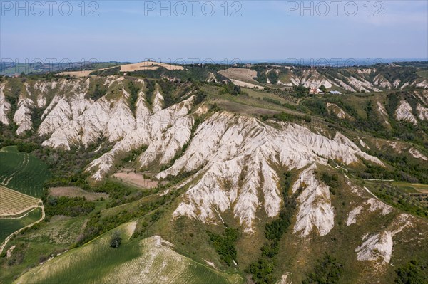 Aerial view of a hilly landscape with erosion valleys