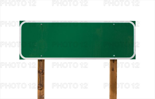 Blank green road sign with wooden posts isolated on a white background
