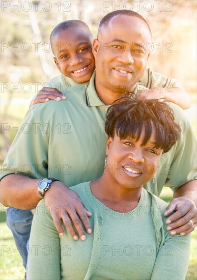 Beautiful happy african american family portrait outdoors at the park