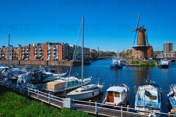 View of the harbour of Delfshaven with the old grain mill known as De Destilleerketel