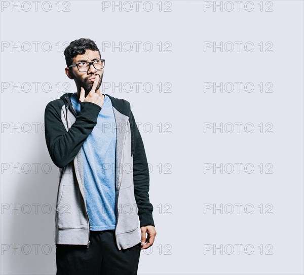 Person wondering with hand on chin isolated