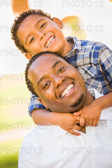 Happy african american father and mixed-race son playing at the park