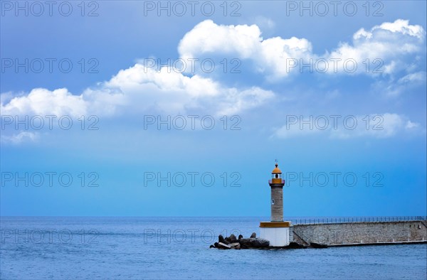 A lighthouse on the shore of a pier