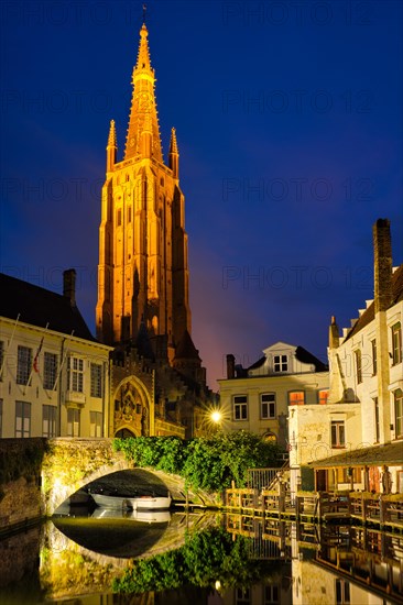 Church of Our Lady and canal illuminated in the night. Brugge Bruges