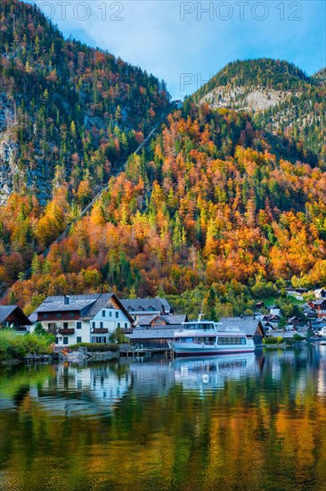 Austrian tourist destination Hallstatt village on Hallstatter See lake lake in Austrian alps with tourist boat