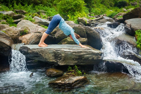 Young sporty fit woman doing yoga asana Adho mukha svanasana