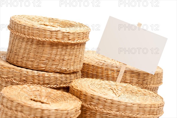 Various sized wicker baskets with blank sign isolated on white