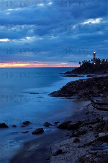 Kovalam Vizhinjam lighthouse on beautiful Arabian sea coast during sunset