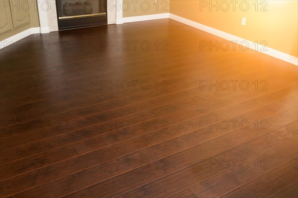 Beautiful newly installed brown laminate flooring and baseboards in home