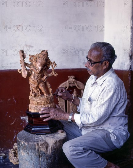 A craft man with his sandalwood Ganesha in Mysuru or Mysore