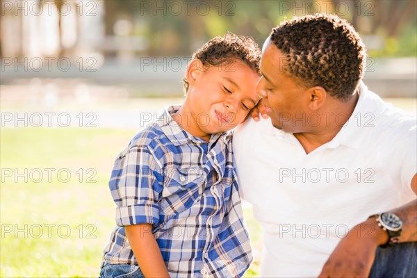 Happy african american father and mixed-race son playing at the park