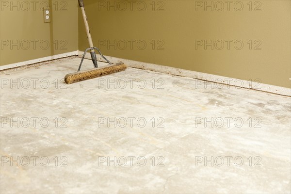 Blank concrete house floor with broom ready for flooring installation