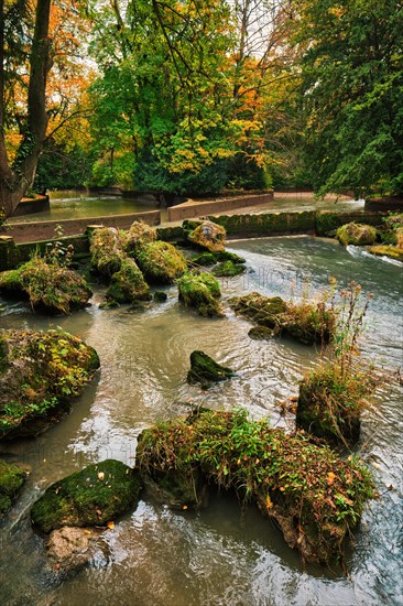 Munich English garden Englischer garten park and Eisbach river with artificial waterfall