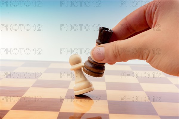 Person playing chess game making a move on board