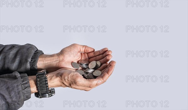 Hands with several coins in isolated background