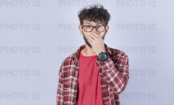 Close up of a man covering his nose