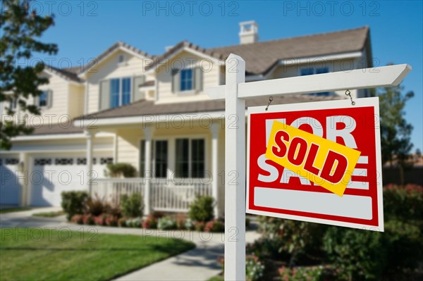 Sold home for sale real estate sign in front of new house