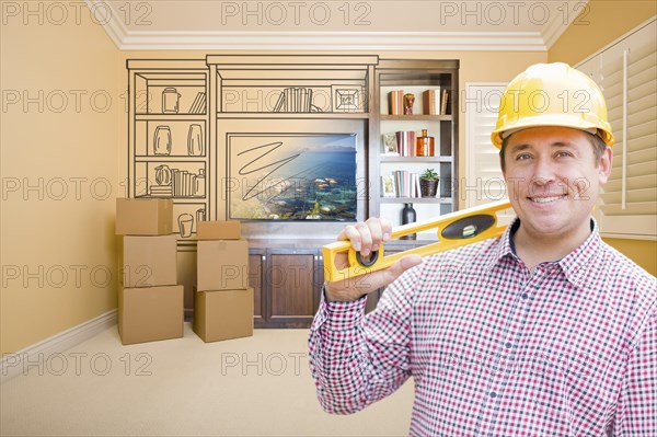 Male construction worker wearing hard hat in room with drawing of entertainment unit on wall