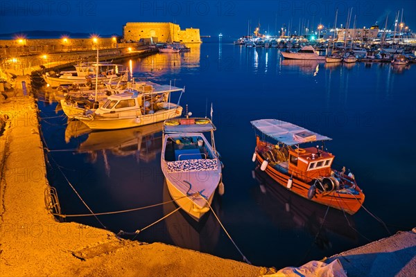 Venetian Fort Venetian fortress of Koules Castello a Mare castle in Heraklion and moored Greek fishing boats in port