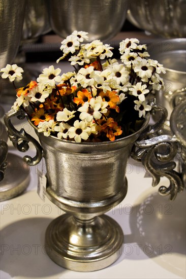 The Flower pot with beautiful fake flowers in it