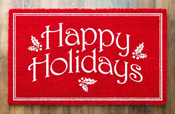 Happy holidays christmas red welcome mat on wood floor background