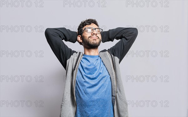 Relaxed person with closed eyes with hands behind his head isolated