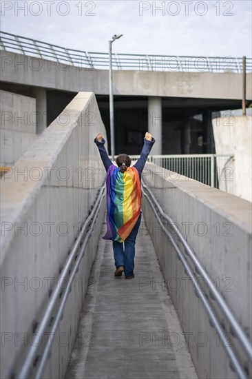 Woman from the back holding lgbt flag