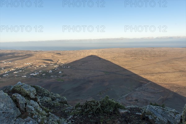 Mountain shadow in the shape of a triangle in the landscape