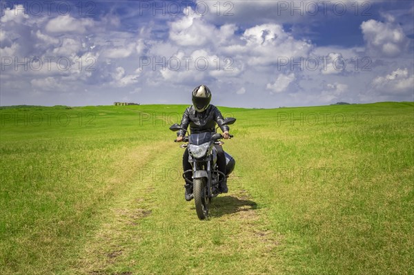 Biker man on a country road