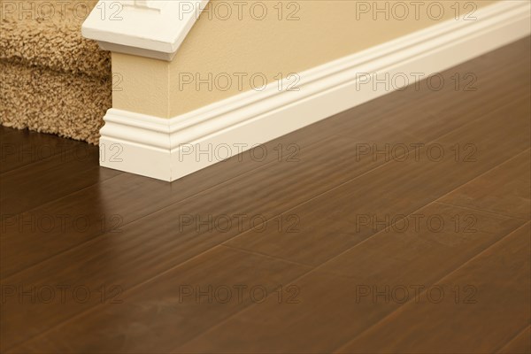 Beautiful newly installed brown laminate flooring and baseboards in home