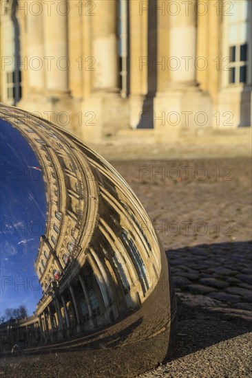 Reflection of the Palais du Gouvernement in a metal hemisphere