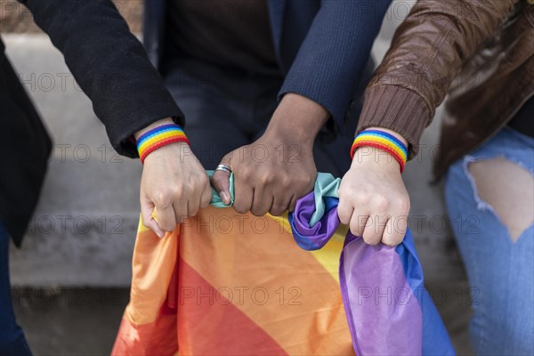 Multi ethnic lgbt gruup wearing lgbt wristbands