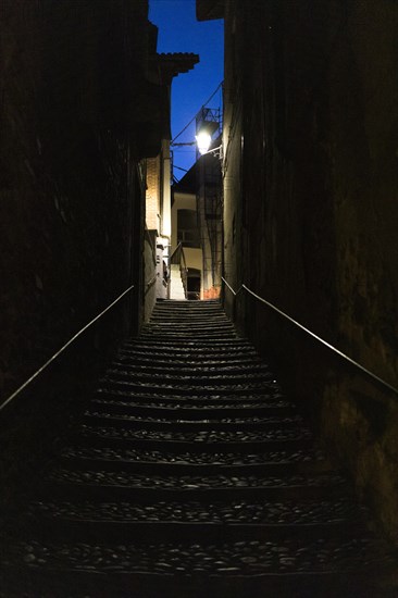 Narrow dark alley with stairs in Cannobio