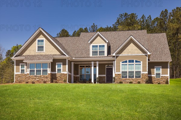 A newly constructed modern home facade and yard