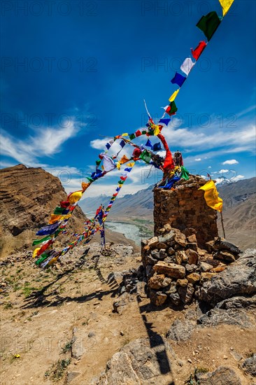 Buddhist prayer flags lungta with Om mani padme hum mantra written on them in Spiti Valley in Himalayas