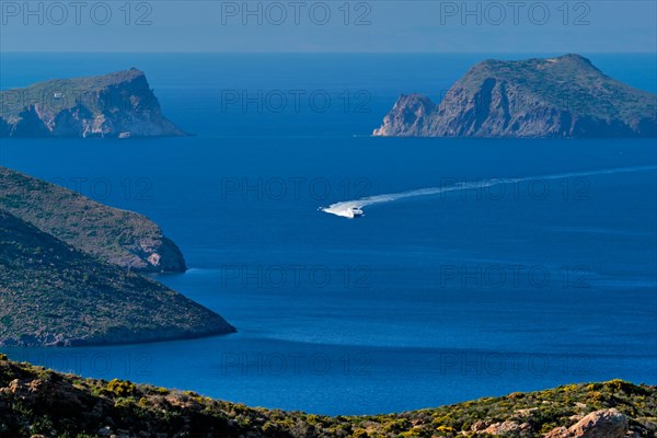 Speeding speed boat catamaran ferry vessel in Aegean sea near Milos island on summer day in Greece