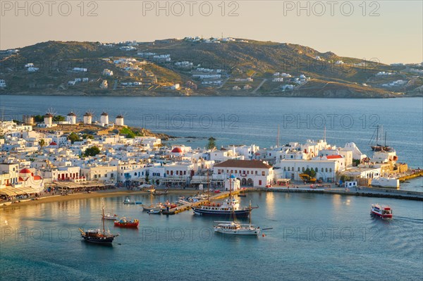 View of Mykonos town Greek tourist holiday vacation destination with famous windmills