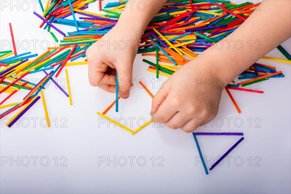 Kid making rectangular and triangle shape as creative concept